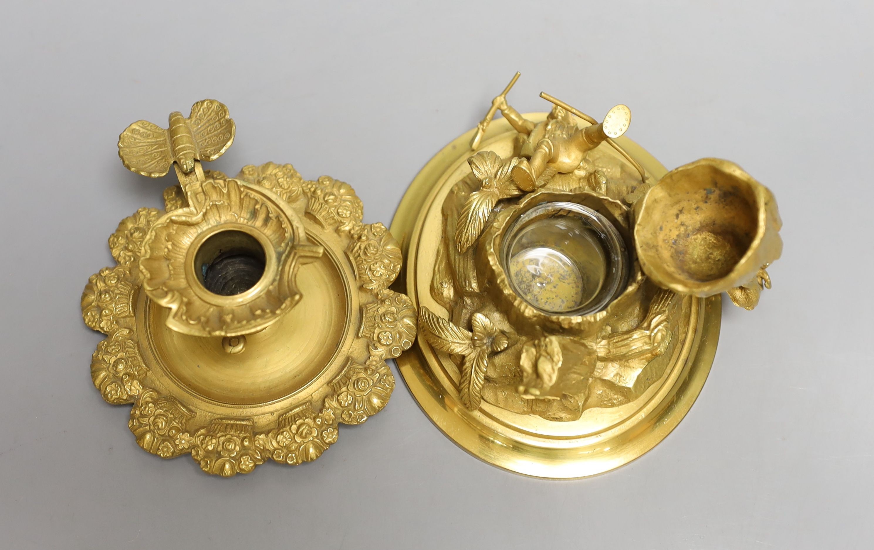 An ormolu mountainous and figurative inkstand and butterfly handled chamber stick, Inkwell 13cms high.